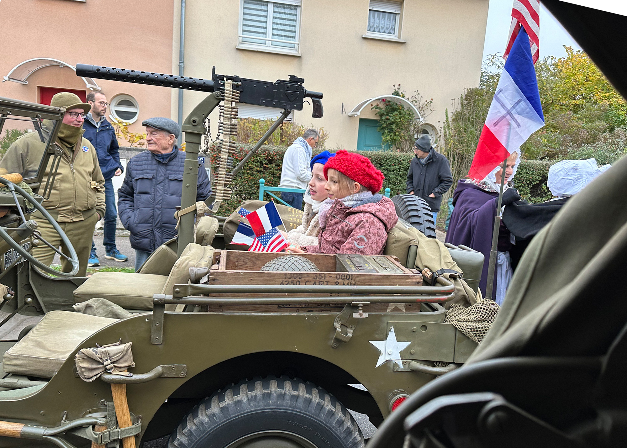 During a stop in Guenange, two young French girls take the opportunity to ride in the back of a Jeep.