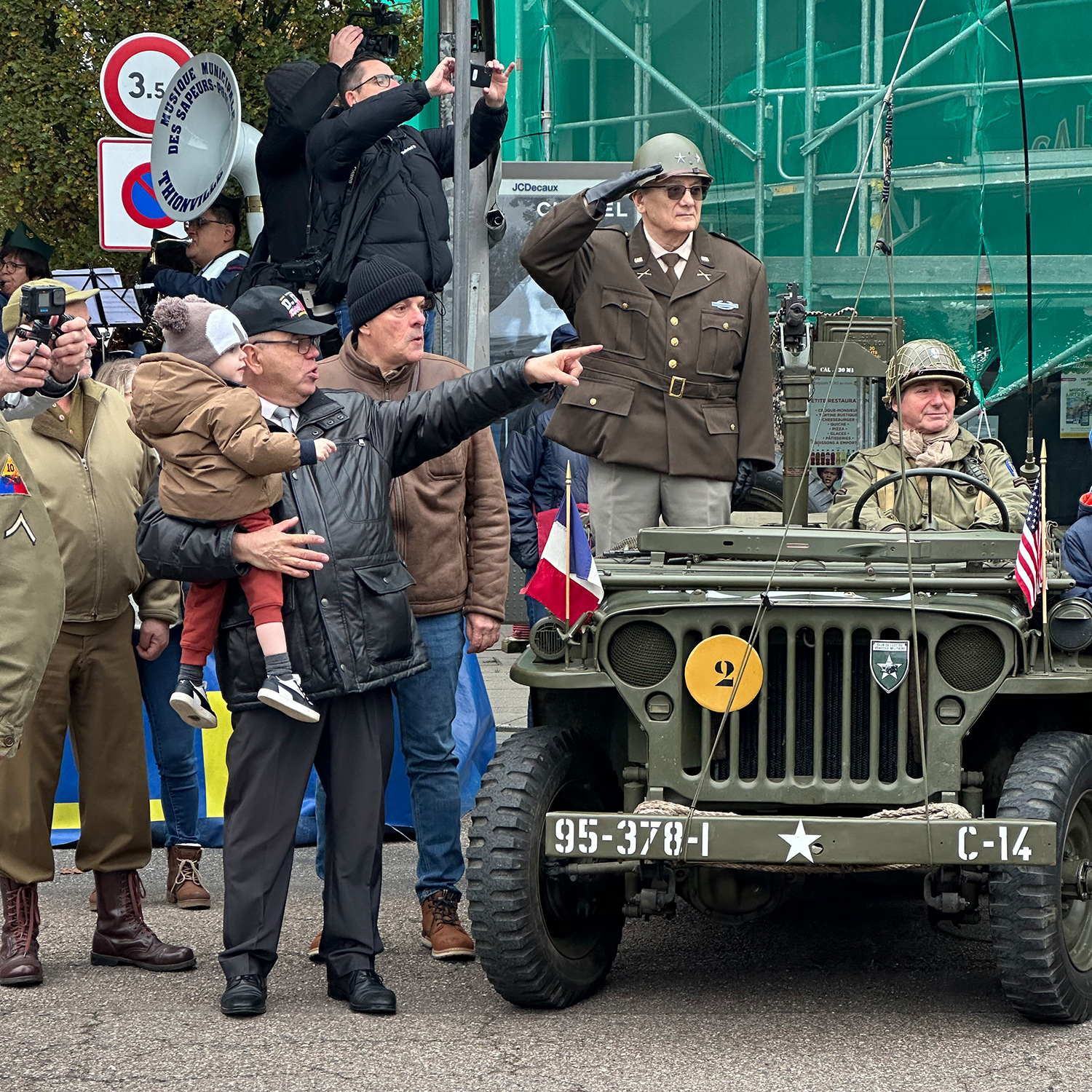 Pascal Moretti holds his grandson during the parade in Thionville. Gérard Dodeller serves as the driver for “General Walker,” the commander of XX Corps in Patton’s Third Army in WWII.