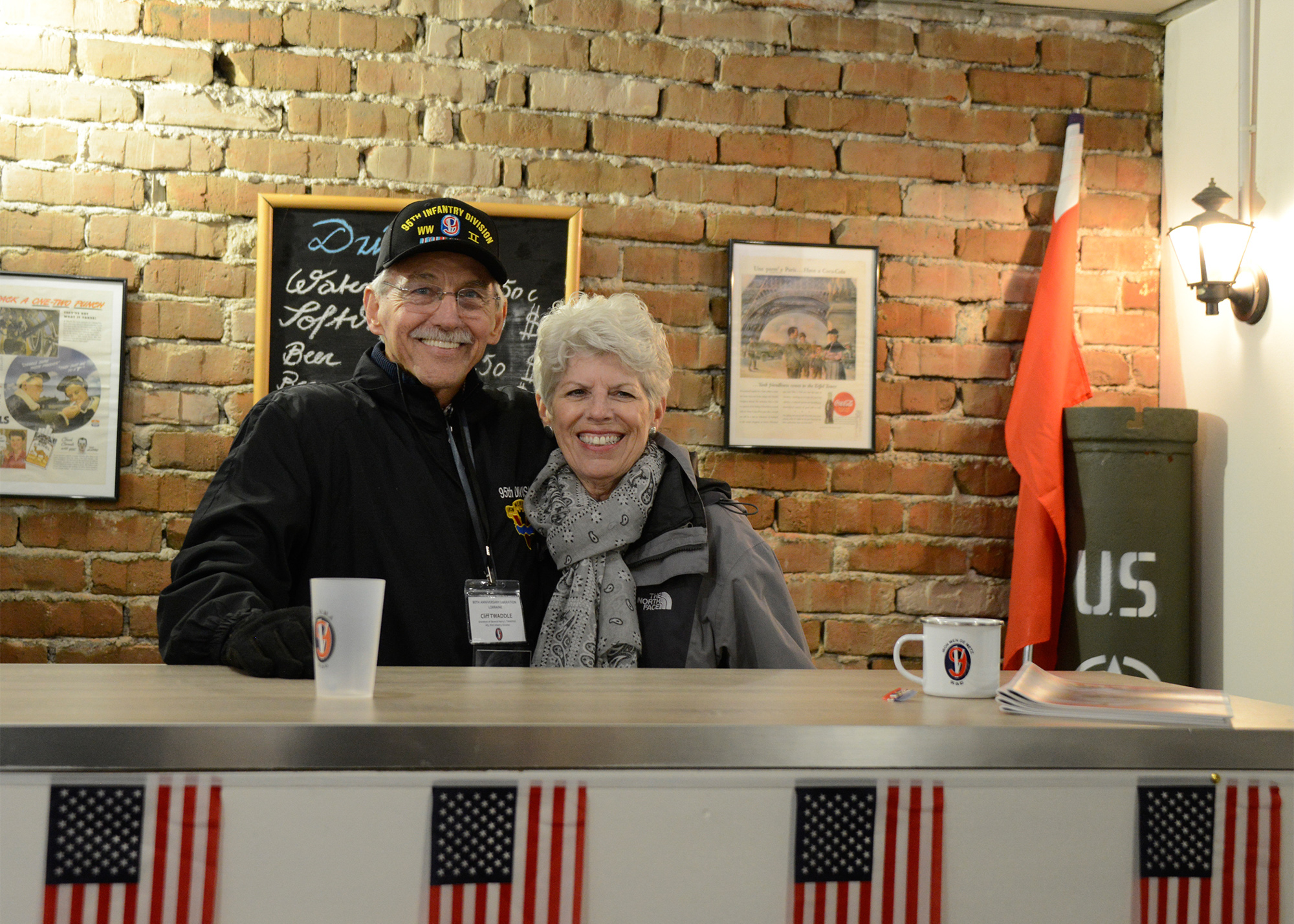 Clif and Kathy Twaddle behind the counter at Twaddle’s Corner. This “bar” was established at the C.L.V.M.A. motorpool in 2019 and was dedicated in honor of MG Harry L. Twaddle, commanding general of the 95th ID throughout WWII and Clif’s grandfather.