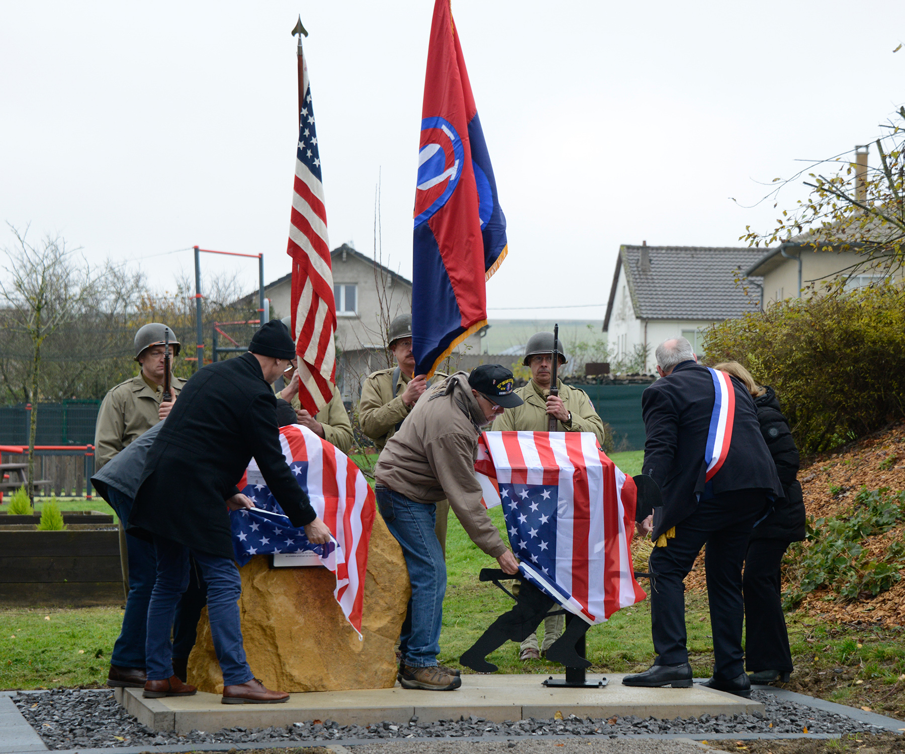 Clif Twaddle, Fred Muller, Mike Flora and Momerstroff Mayor Bernard Colbus unveil a monument dedicated to Walter O. Brunko.