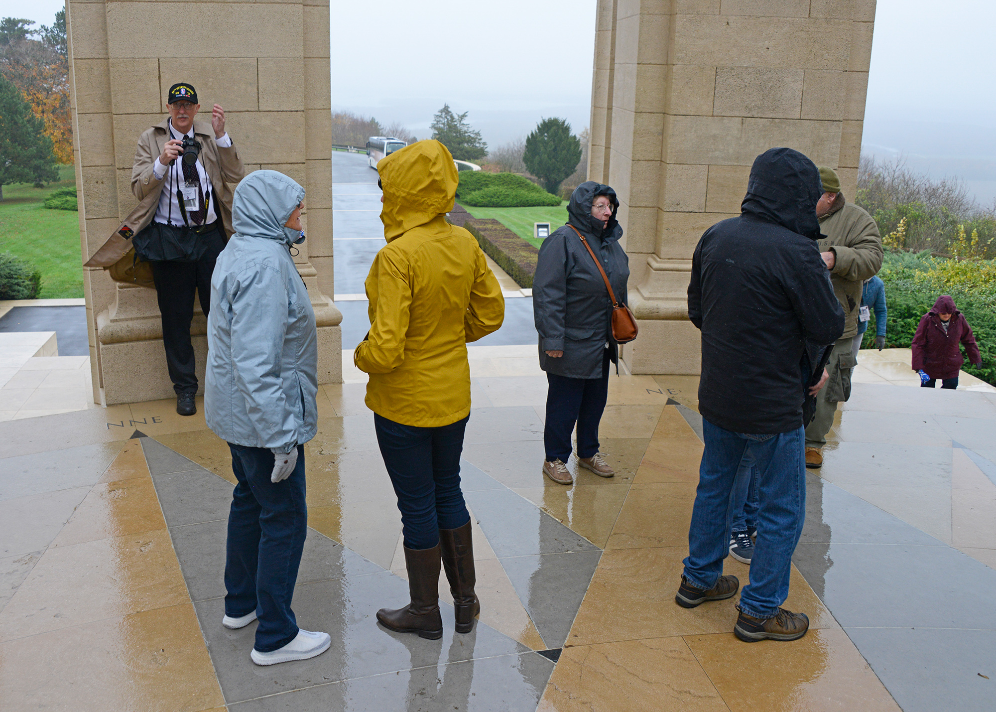 After braving the elements in the walk from the bus to the monument, members of our group take temporary shelter from the rain in the Montsec American Monument.