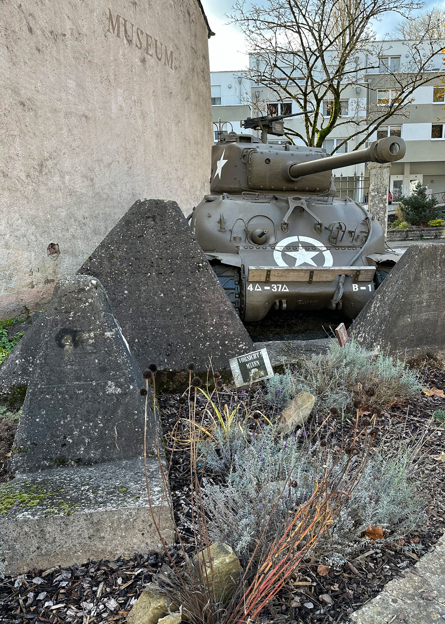 A late WWII M4A3E8 Sherman tank guards the entrance of the National Museum of Military History in Diekirch.