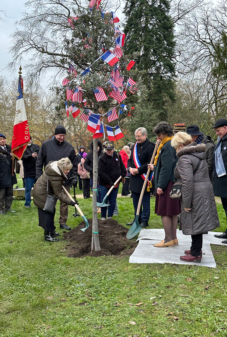 Nancy Duno Broadway helps to plant an oak tree in remembrance of her father, Anthony Duno, Co. G, 379th Reg. and the 80th Anniversary of the Liberation of Metz.