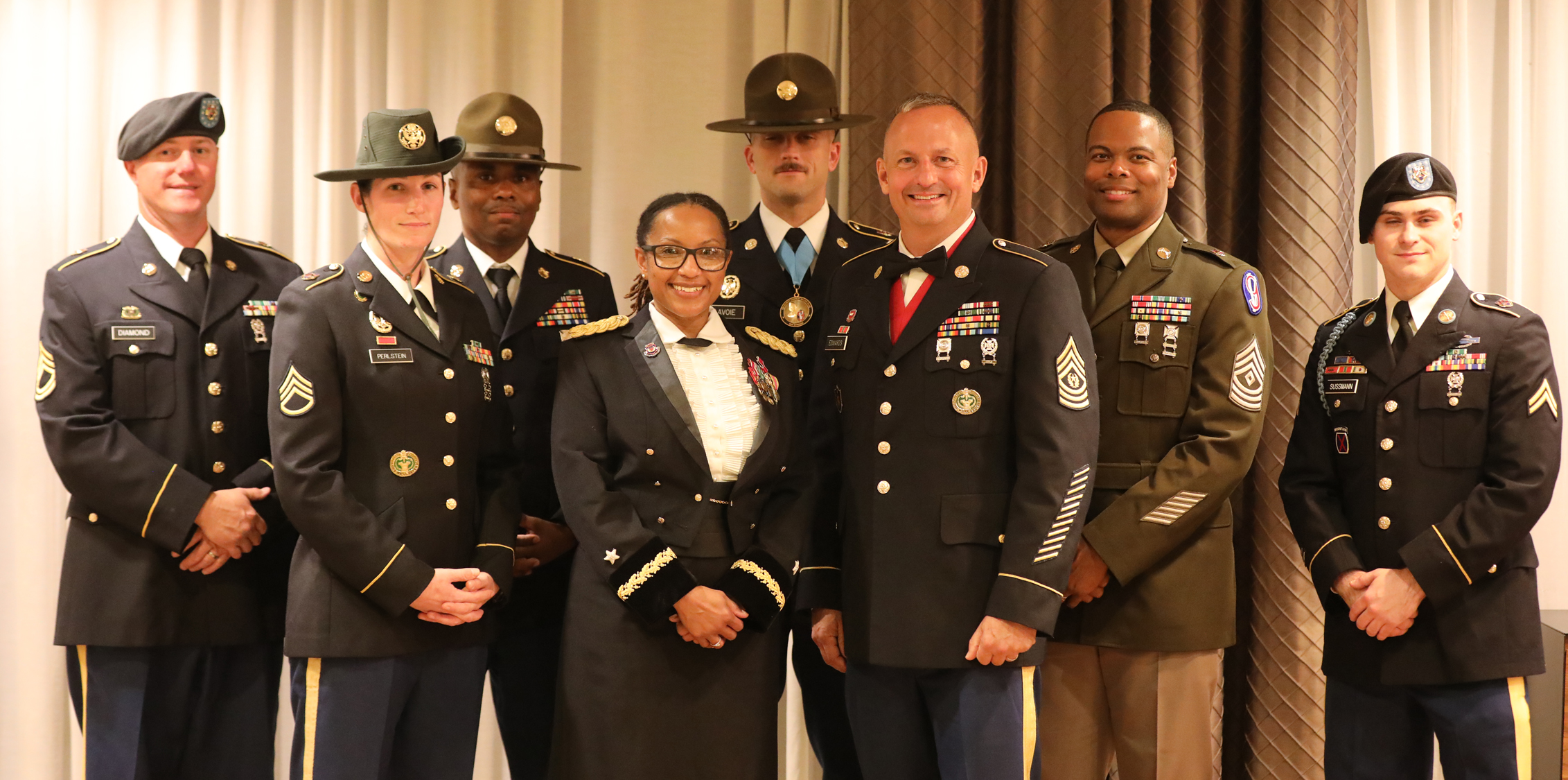 After greeting and thanking members of the 95th Training Division (IET) Color Guard, Brig. Gen. Daphne Davis and Command Sgt. Maj. Kyle Edwards (middle, front row) pose with the Color Guard for a photo at the Formal Banquet. In addition to serving in the Color Guard, Staff Sgt. James Lavoie (middle, back row) is the 2023 Drill Instructor of the Year (DOY) and a member of the Staff Sgt. Andrew Miller Club (SAMC).