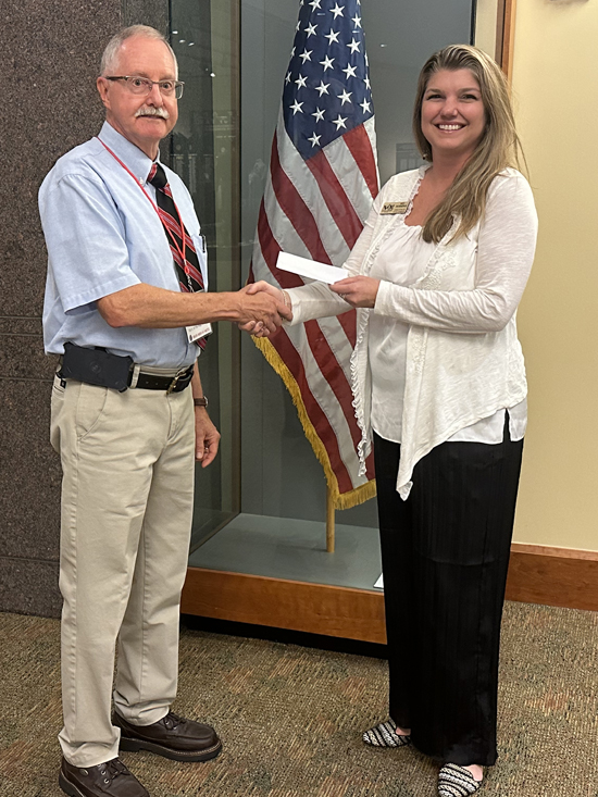 On behalf of the 95th Division Foundation, Treasurer Mike Flora presents a donation to Kei Robbins, Director of Development at the National Infantry Museum.