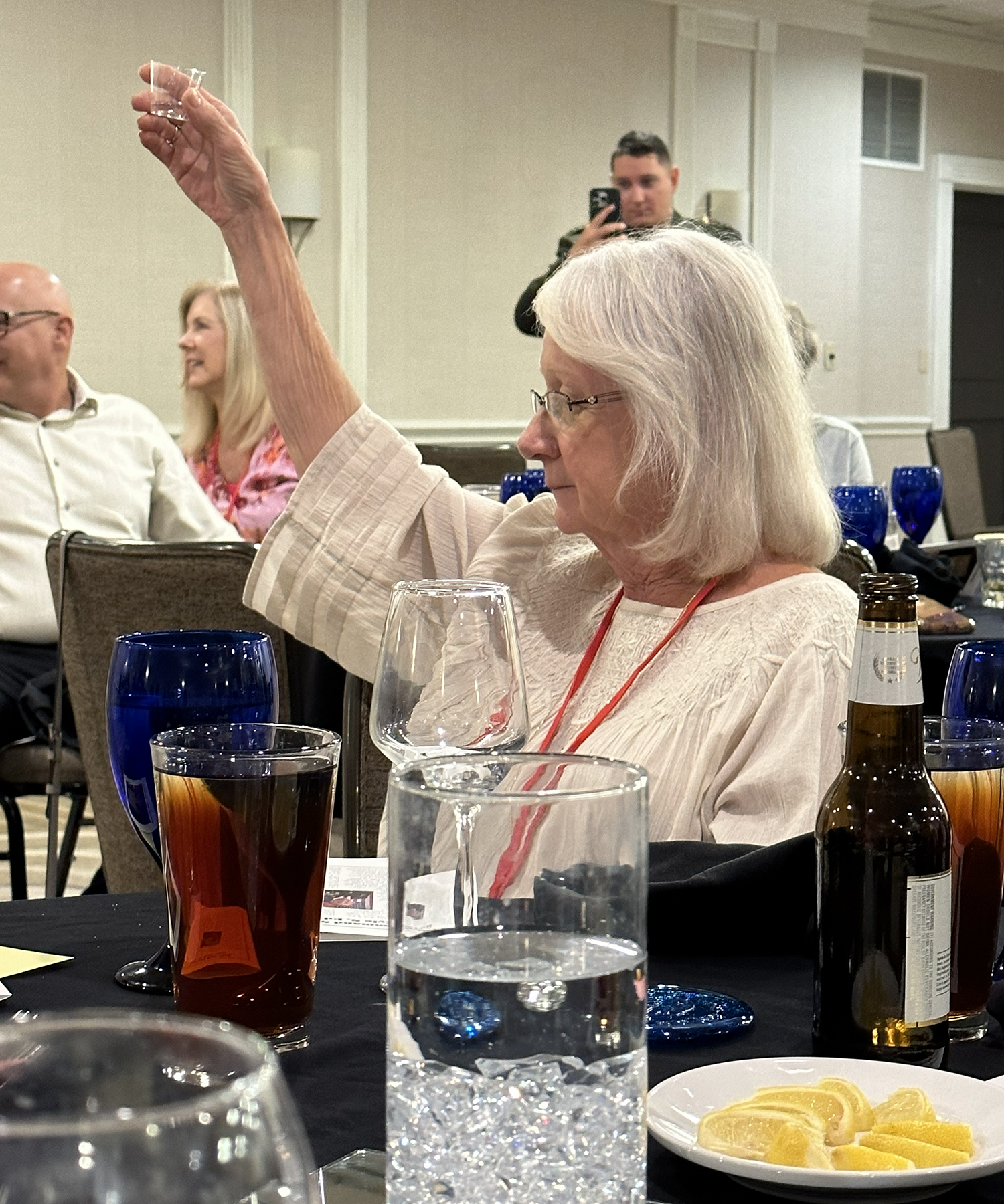 Jane Harvey raises her glass during the Mirabelle Toast.