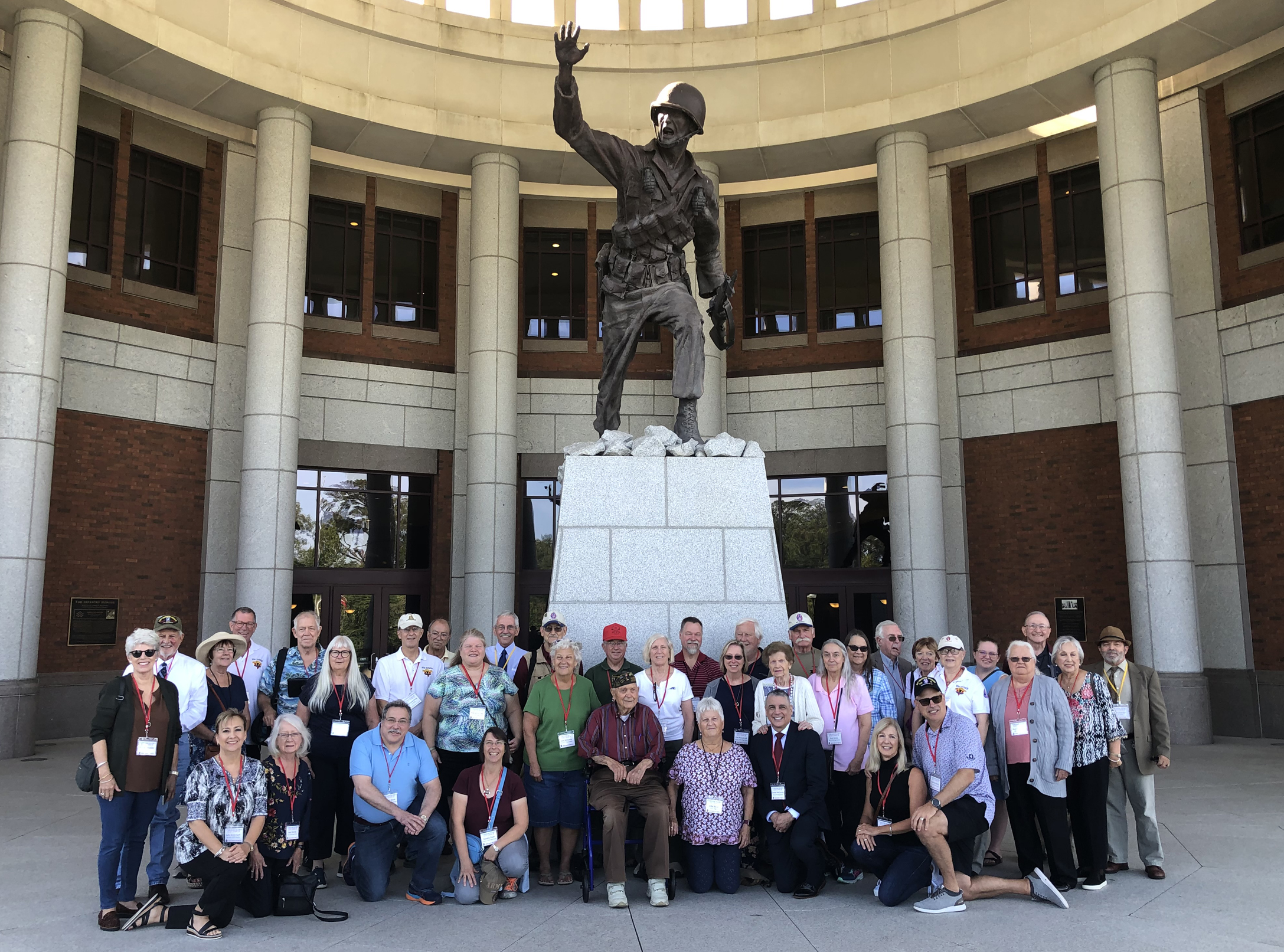 The 95th Division family poses in front of the National Infantry Museum at Fort Moore, Oct. 5, 2023. The group toured the museum, then proceeded to the Walk of Honor for the dedication of two benches honoring Maj. Gen. Harry L. Twaddle and Staff Sgt. Andrew Miller