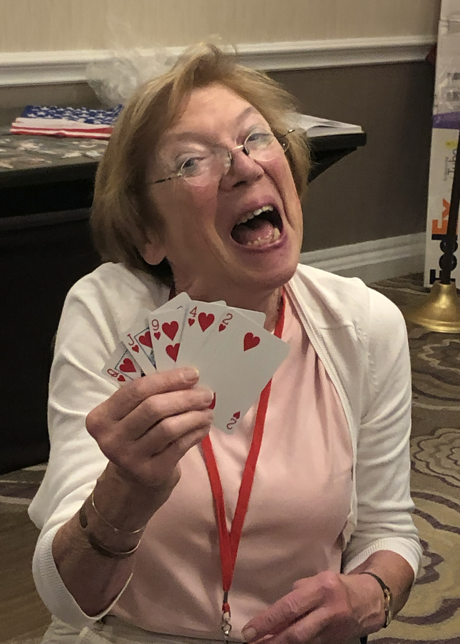 Françoise Leclercq proudly shows her winning hand at a poker game in the Hospitality Room.