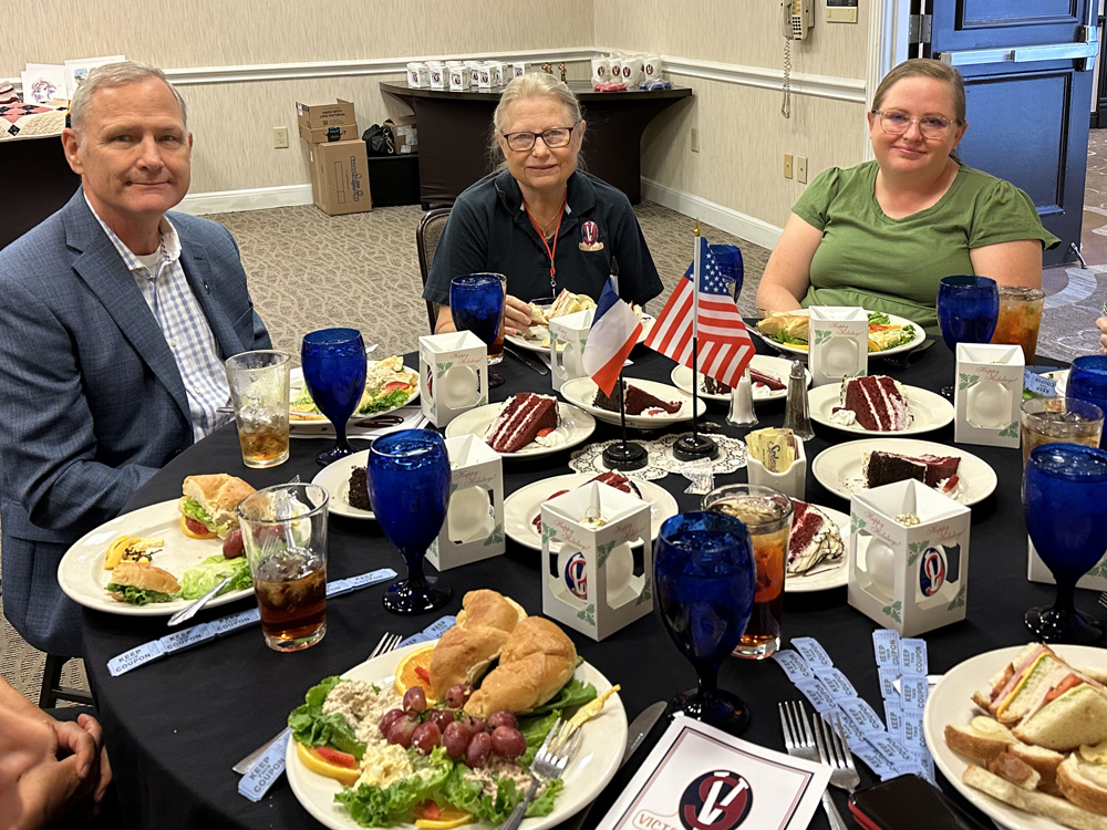 Guest speaker Col. (R) David Moore, joins Susan Feely and Meg Graf at the Victory Belle Luncheon, Sat., Oct. 7, 2023, before addressing the ladies (and gentlemen, who were also invited to listen to David’s inspirational words).