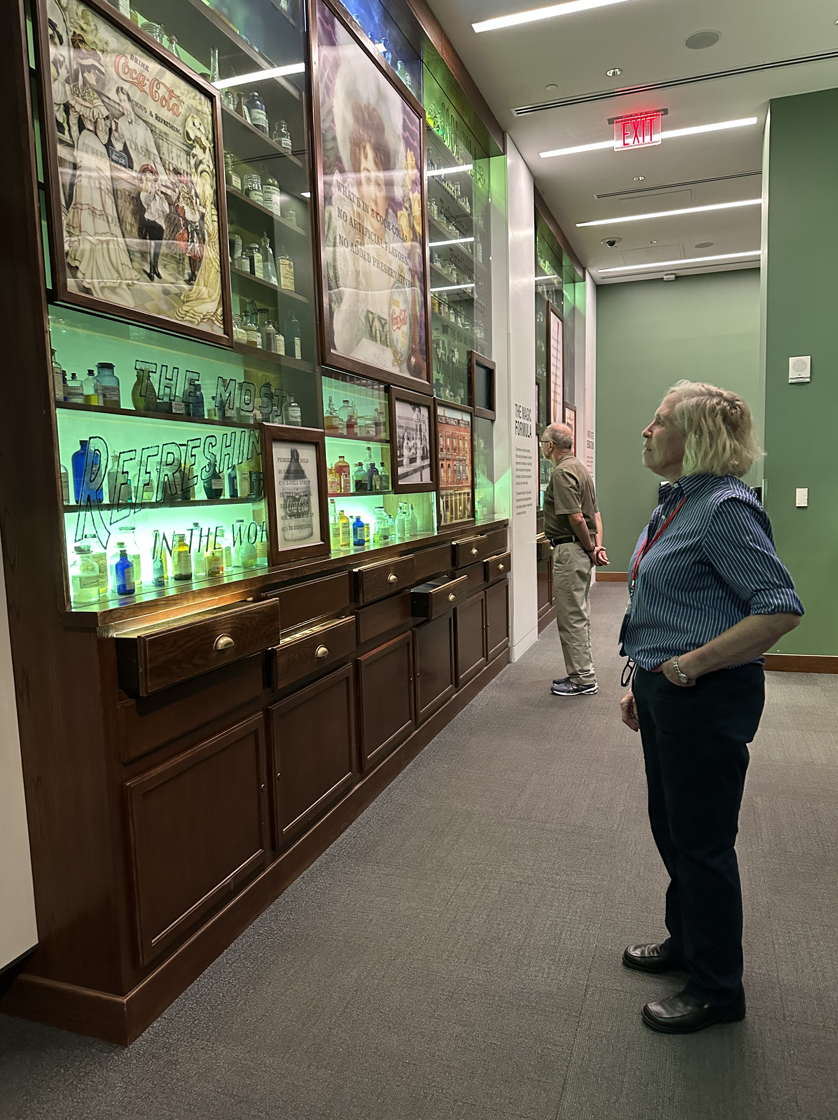 While in downtown Atlanta, Lt. Col. (R) Marty Tydings and Mike Flora took the opportunity to visit World of Coke. During their tour, they viewed a display of chemicals from the pharmacy of Coca-Cola inventor John Pemberton, a pharmacist in Atlanta.