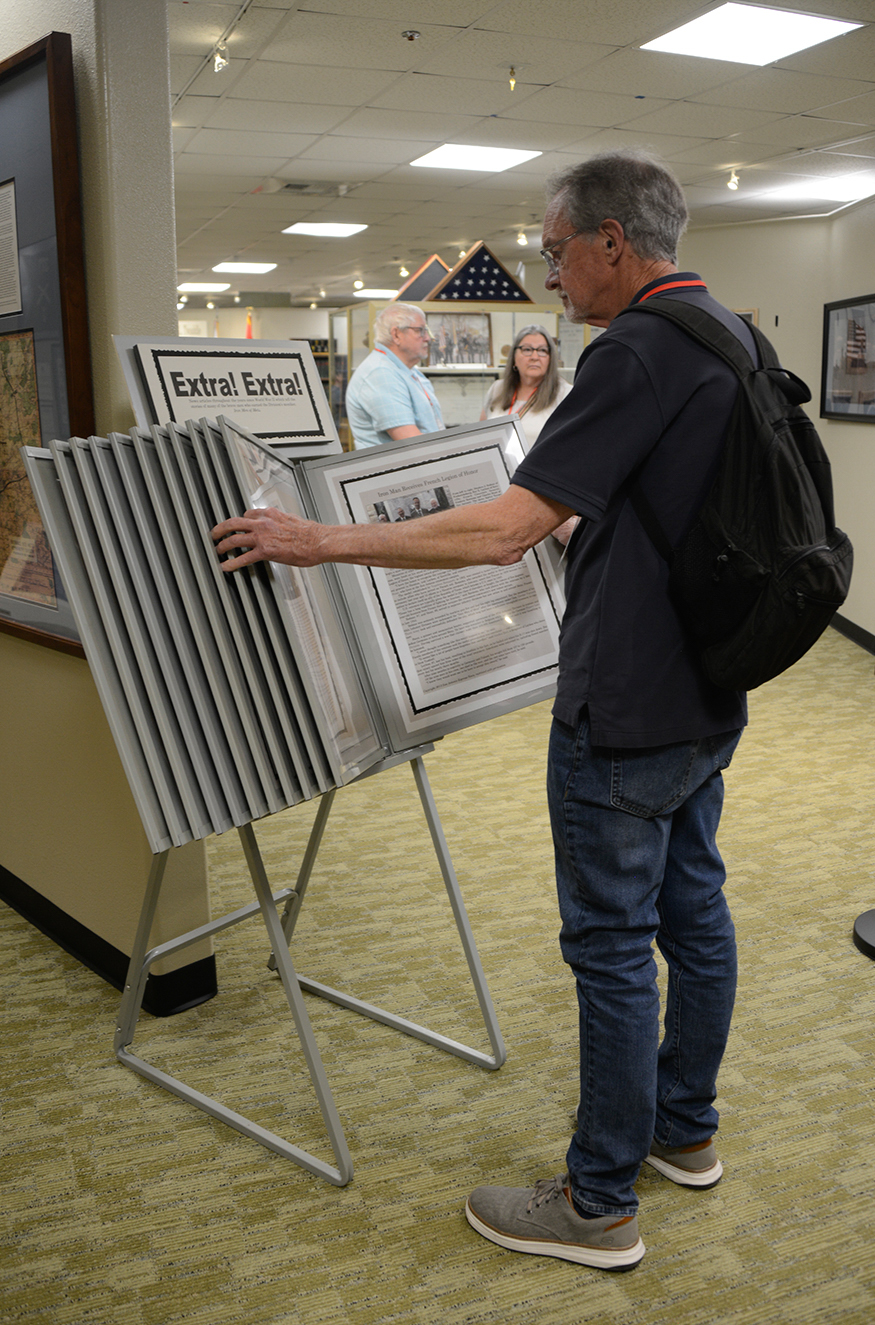 First-time reunion attendee and former newspaper reporter and editor, John Cannon is particularly interested in browsing through this display of newspaper reports about the 95th Infantry Division in the Memorial in Lawton, Okla. John is the son of John Cannon, 95th Reconnaissance Troop.