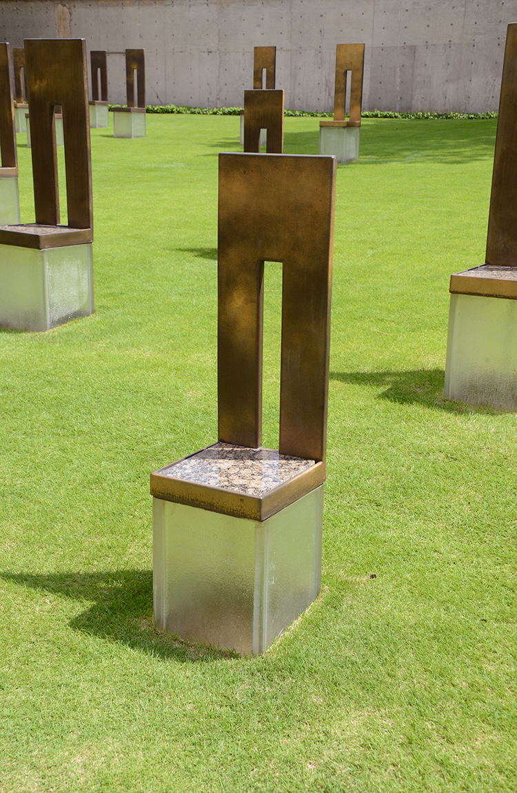 The Field of Empty Chairs at the Oklahoma National Memorial includes 168 empty chairs hand-crafted from glass, bronze and stone. They represent those who lost their lives, with a name etched in the glass base of each.