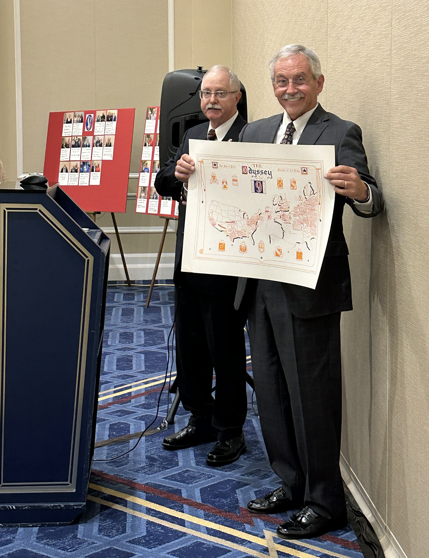 Mike Flora thanks outgoing president Clif Twaddle with an original 95th Infantry Division Odyssey Map drawn by MSG Richard E. Clark.