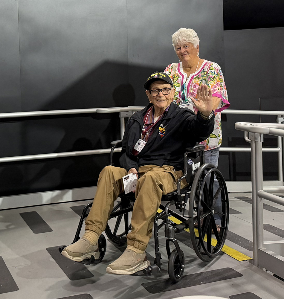 Billie Bauer and her uncle Ceo Bauer are ready to head up the ramp to see a space shuttle training cockpit on display in the U.S. Air Force museum.