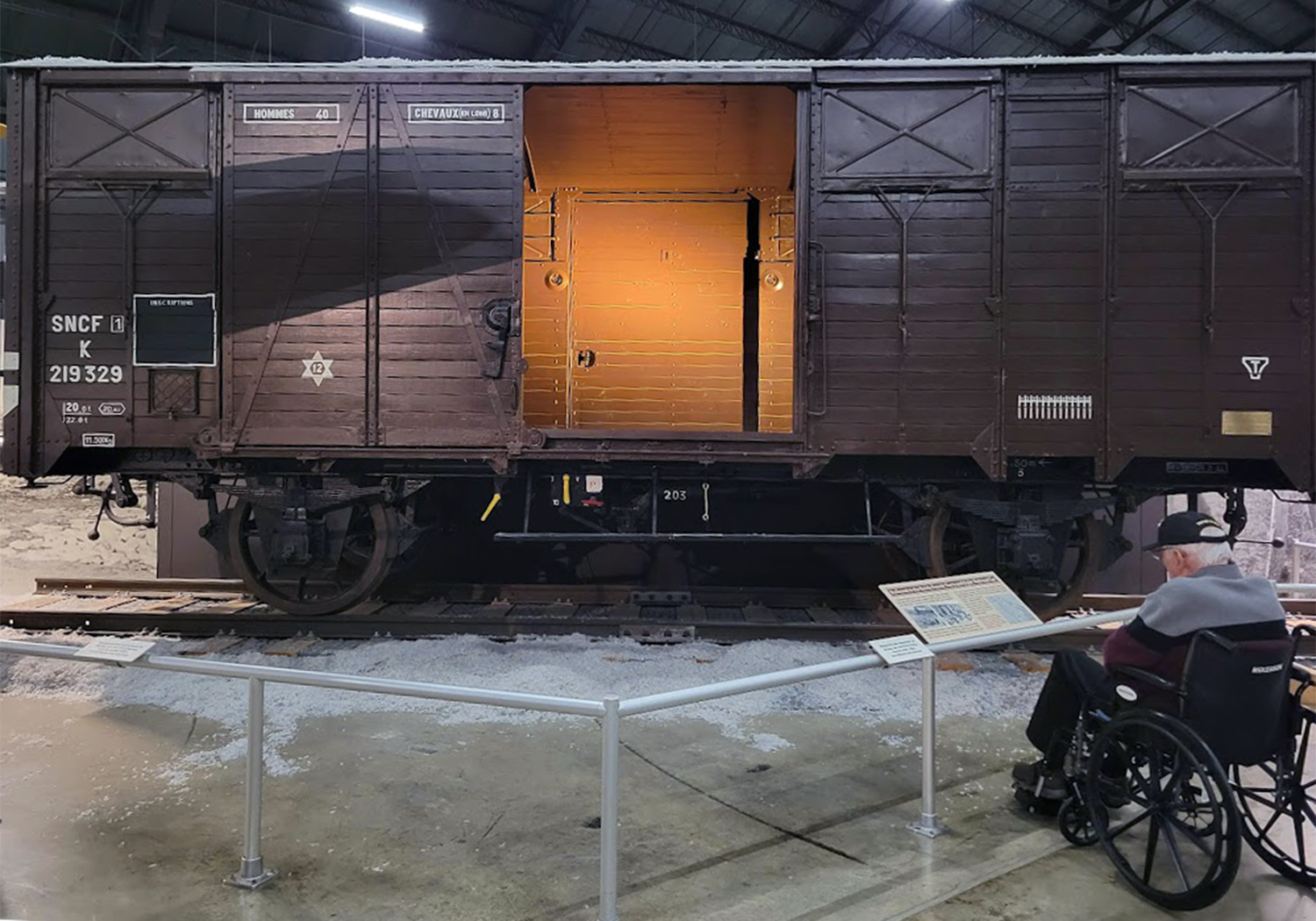 Jim Walker reads about a Forty-and-Eight (40 men or 8 horses) used to transport troops or horses, POWs and civilian prisoners to concentration camps.