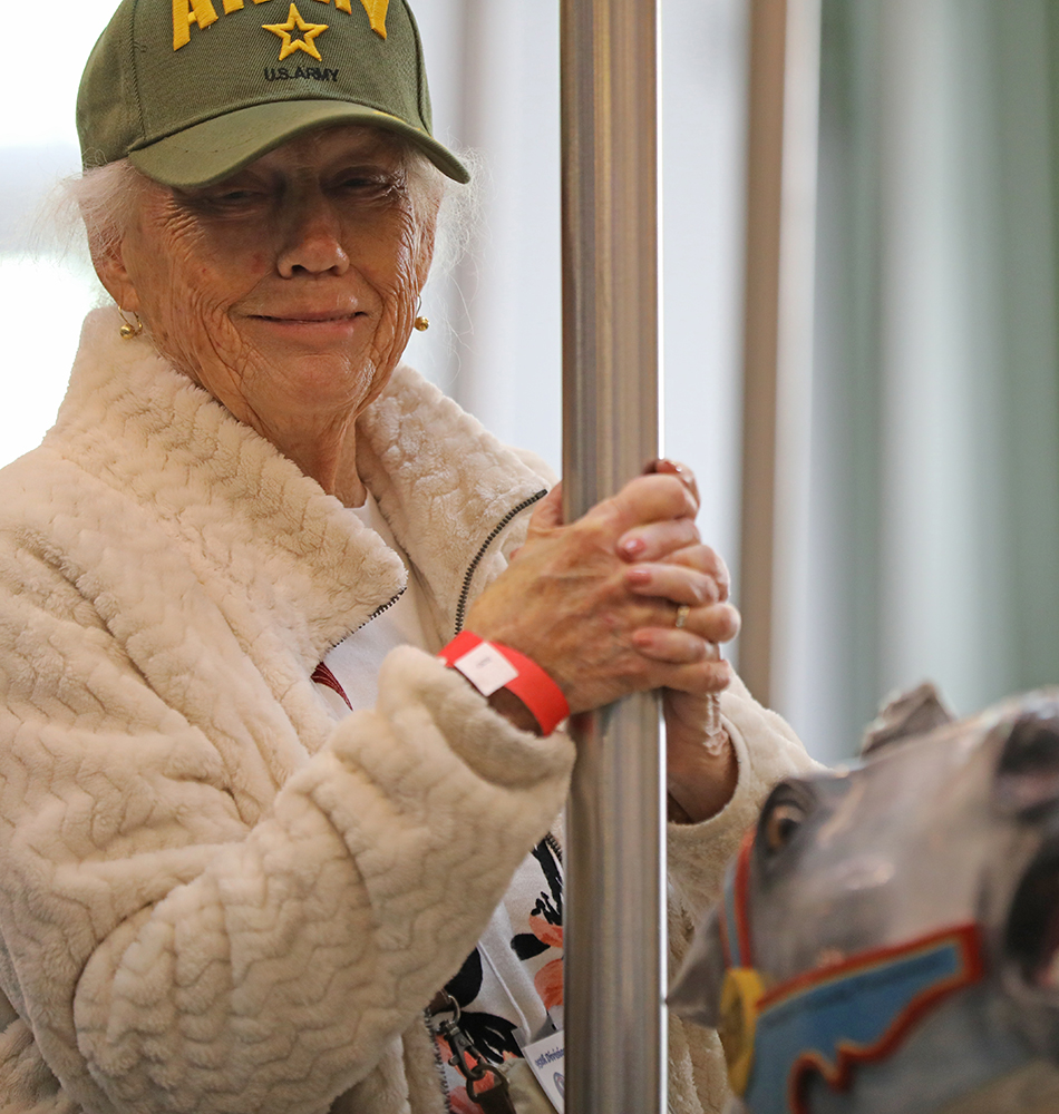 Margaret Jamison joins others riding the carousel at Carillon Historical Park.
