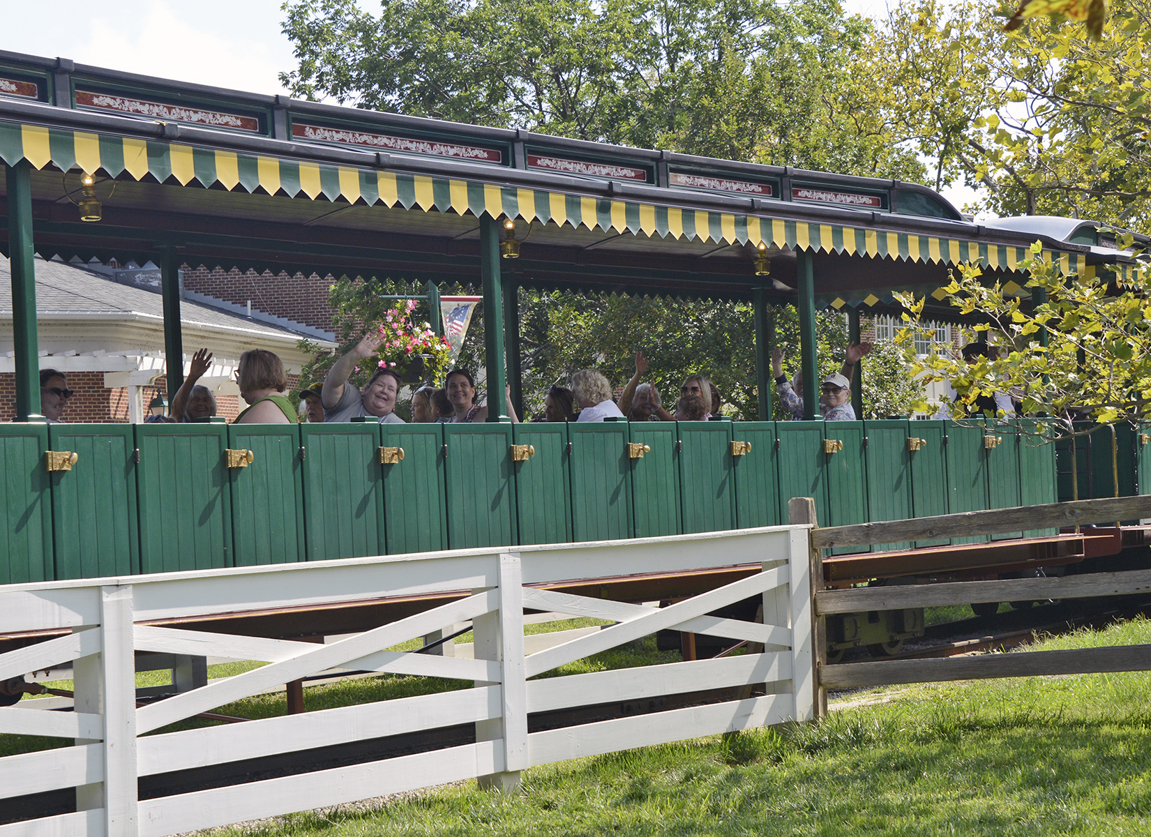 Members of the 95th Division Legacy Association wave from the Carillon Park R.R. as they tour the Historical Park.