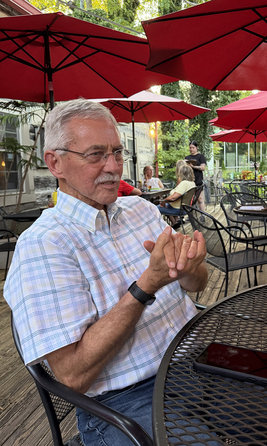 Tuesday, Aug. 18, 2026, Clif Twaddle enjoys conversation with friends during dinner on the patio at Ye Olde Trail Tavern in Yellow Springs, the oldest tavern in Ohio.